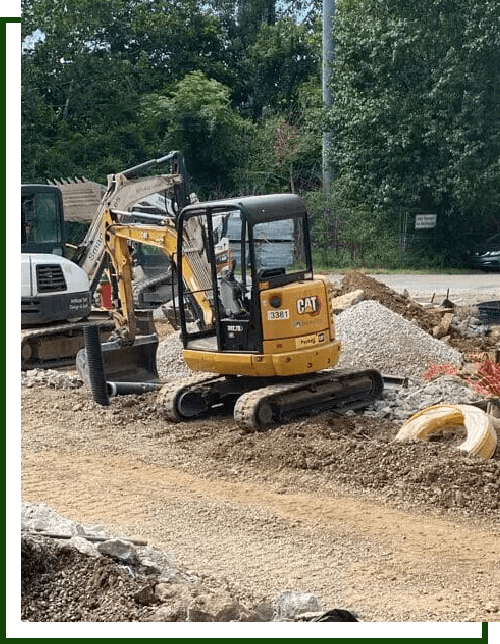 Yellow excavator on gravel construction site.