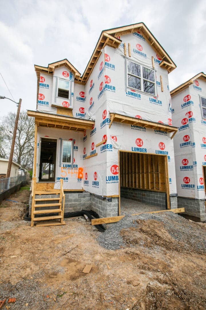 Unfinished house wrapped in lumber paper.